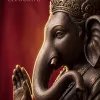 Majestic Lord Ganesha Close-Up with Ornate Crown and Raised Blessing Hand on Rich Crimson Background